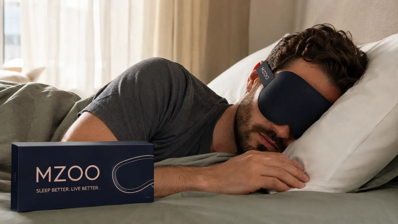 Side sleeper resting on a pillow wearing the MZOO sleep mask with the strap visible around the back of the head